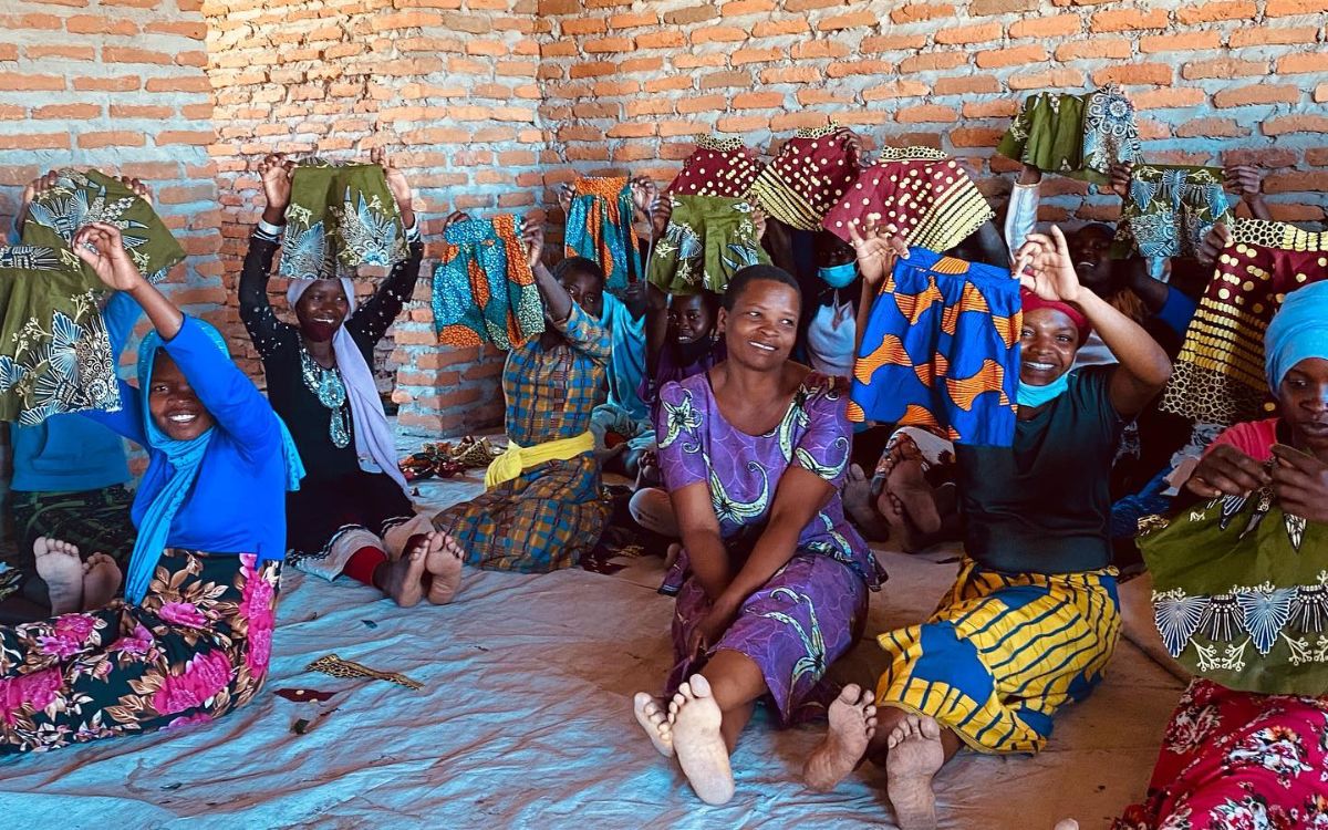 Group of women showing handmade clothes