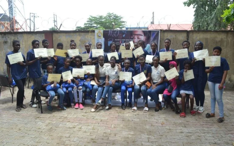 Nigerian girls showing a certificate