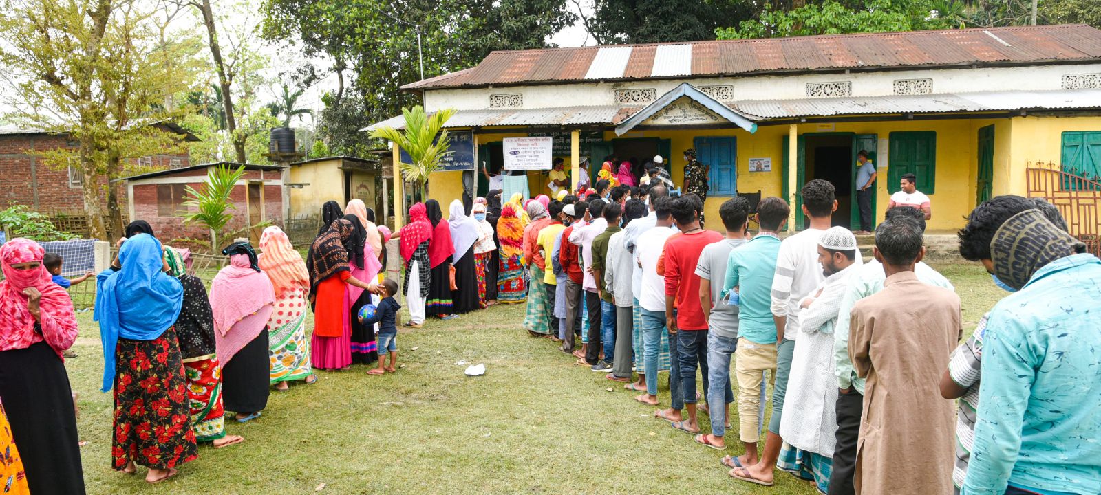 Voters wait in queues to cast their votes at a polling station.Credit: Hafiz Ahmed / Shutterstock
