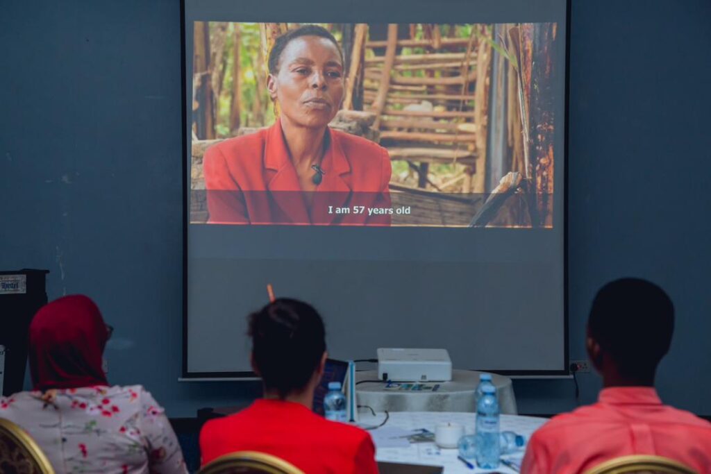 Participants during the Regional Conference watch one of the Victim Stories from our online Community Stories Exhibition