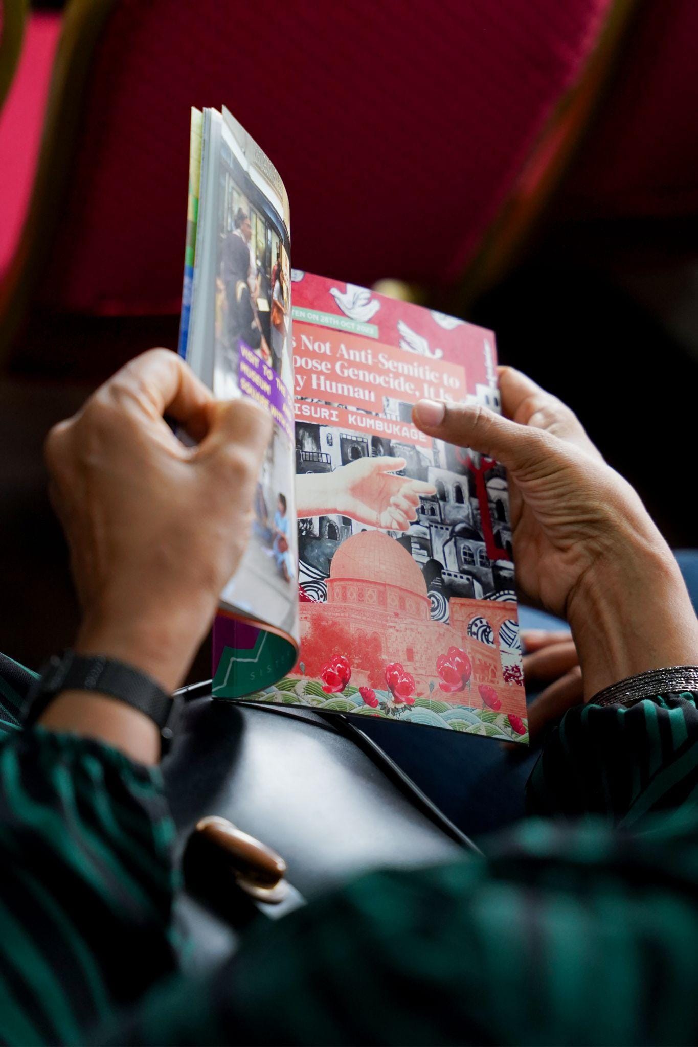 A person holding a magazine in their hands