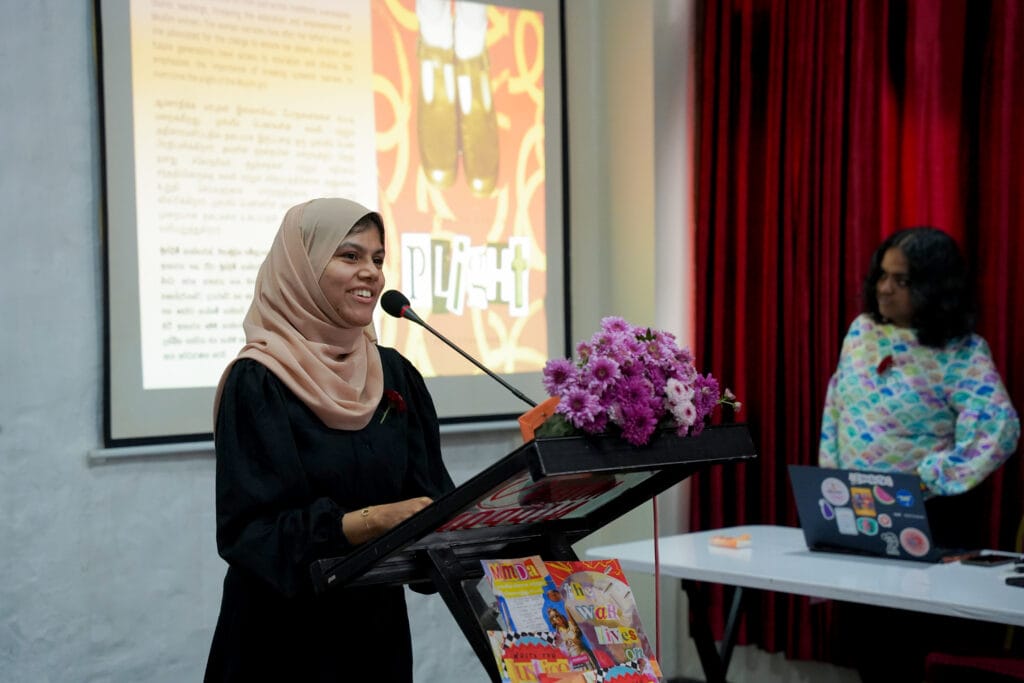 A young woman speaking at a microphone