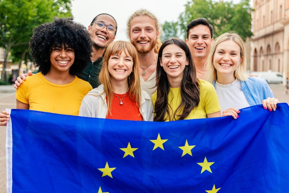 A group of diverse young people with EU flag