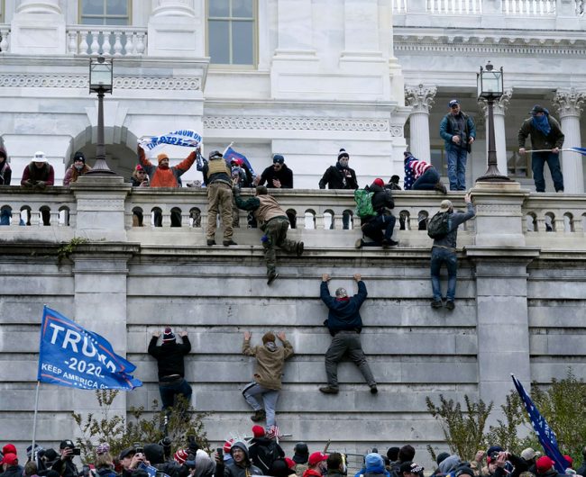 Supporters of Trump climb the west wall of the the U.S. Capitol, Washington, D.C., U.S., Jan. 6, 2021.